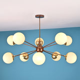 Front elevation of a 10 light brass globe chandelier featuring a central sphere and balanced mid century modern design.
