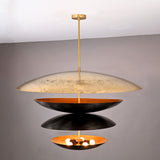 Front angle of illuminated 10-light layered disc chandelier with warm inner glow and contrasting black and gold brass bowls.