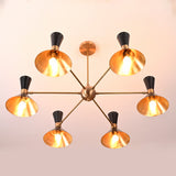 Bottom view of 12-light brass and black mid-century cone chandelier with glowing gold interiors and warm light output.