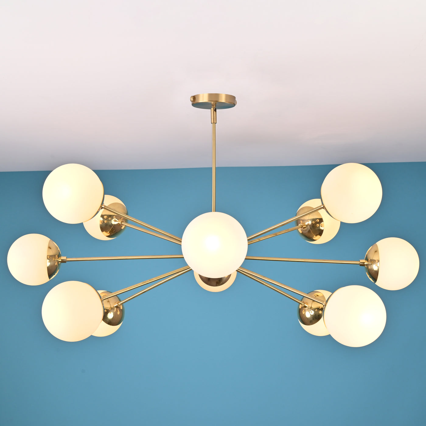 Modern 12 light brass globe chandelier with opal glass shades and symmetrical mid century design