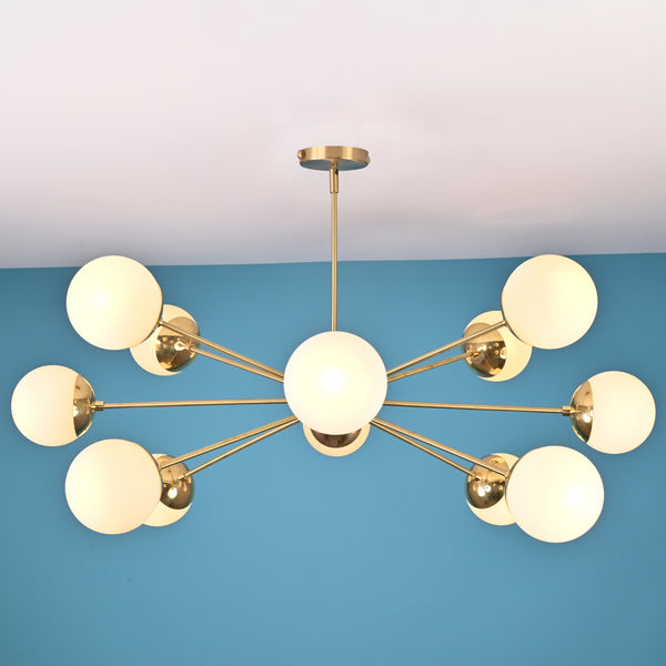 Modern 12 light brass globe chandelier with opal glass shades and symmetrical mid century design