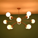 Handmade 12 opal glass brass chandelier producing soft ambient glow with mid century modern aesthetic