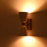 Two-light wall sconce creating warm ambient glow above and below for modern interior walls