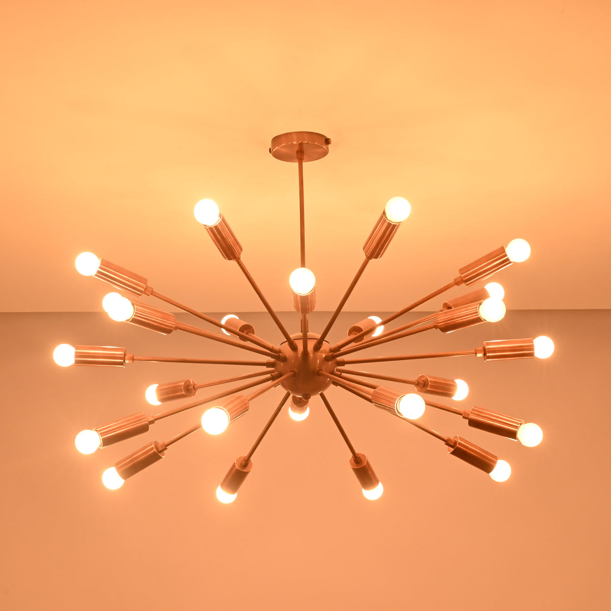Wide view of 24 light brass sputnik chandelier casting warm ambient light across the ceiling.