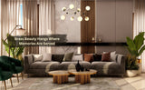Brass and white globe chandelier centered in a stylish living room with gray sofa, green armchairs, and modern accents.