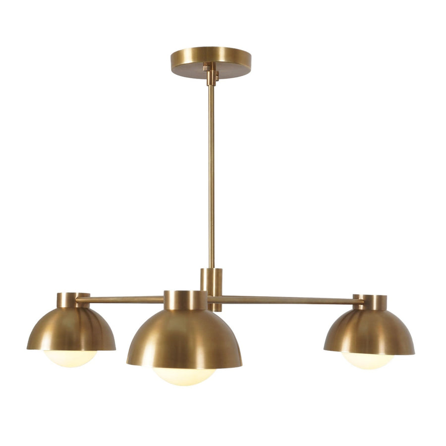 Three-light modern brass chandelier with dome shades and geometric arms, showcasing minimalist mid-century design and warm ambient illumination.