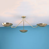 Minimalist 3 light brass bowl chandelier with disc shaped shades mounted close to ceiling