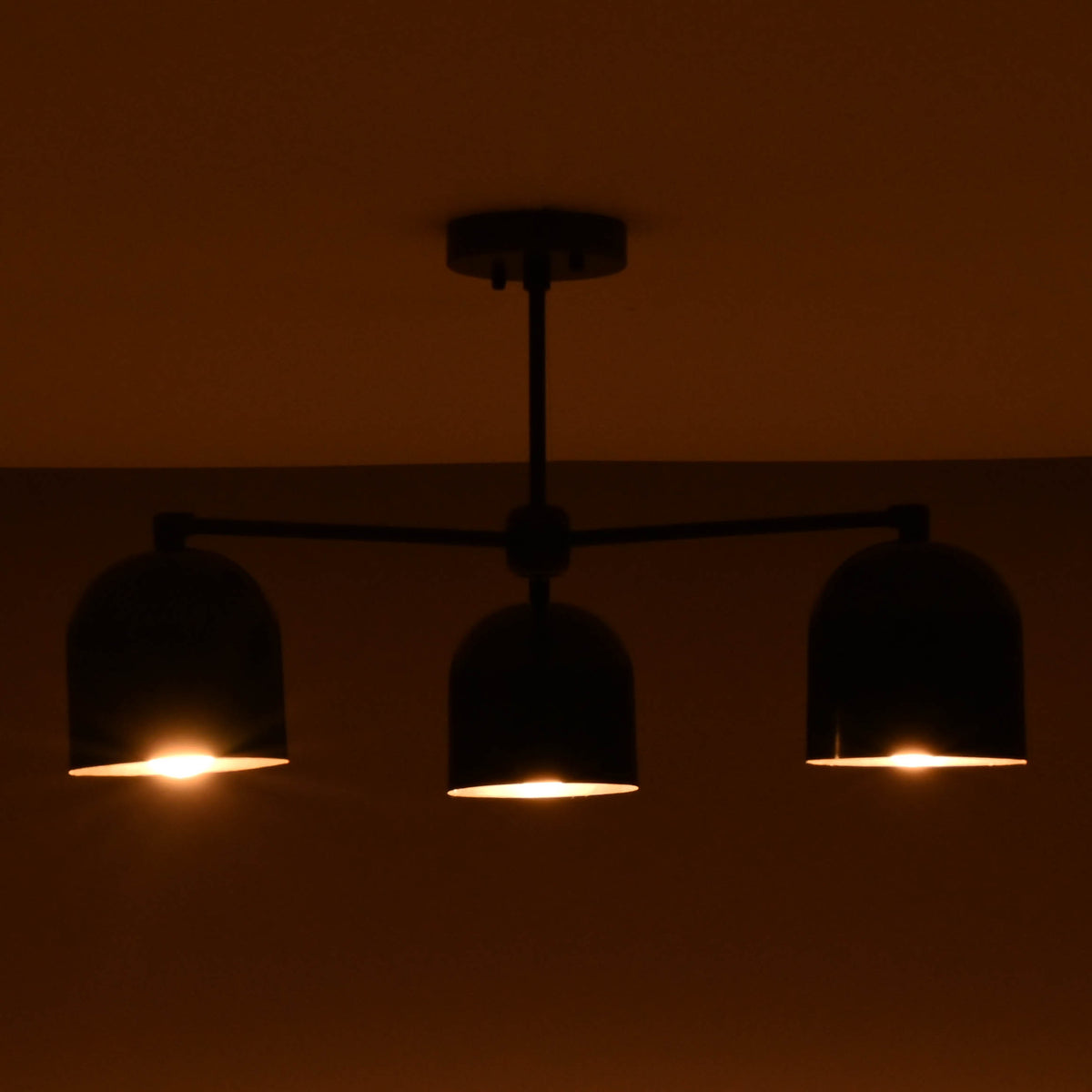 Soft glowing 3 light brass chandelier creating a cozy and inviting atmosphere.