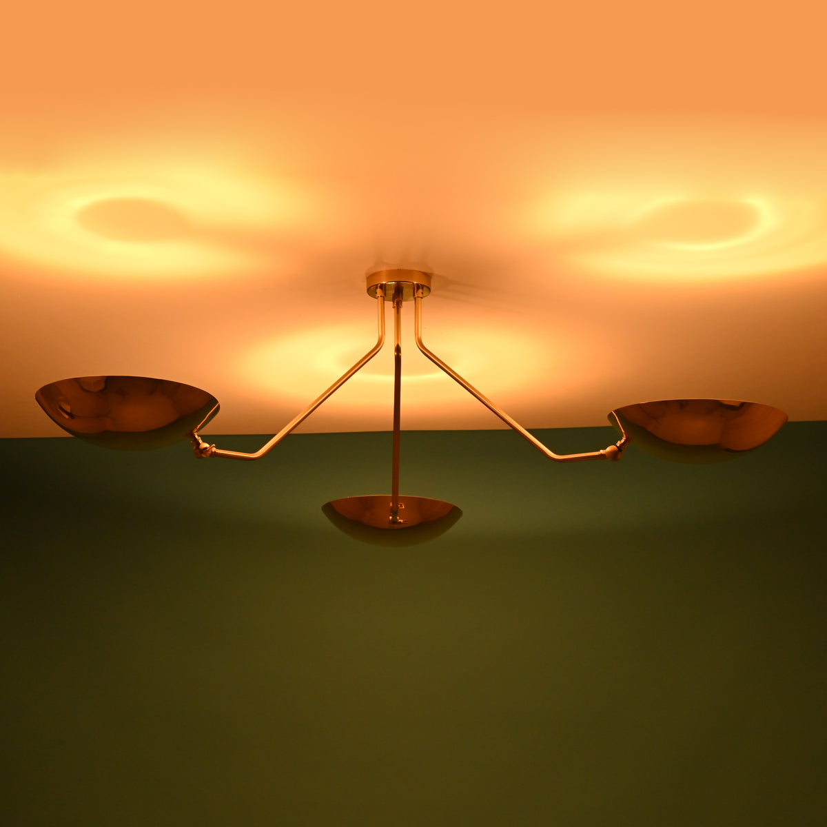 Unlit 3 light brass bowl flushmount ceiling fixture showing solid brass construction and minimalist form