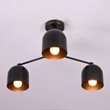 Angled view of a modern industrial 3 light brass chandelier with bowl-shaped shades.