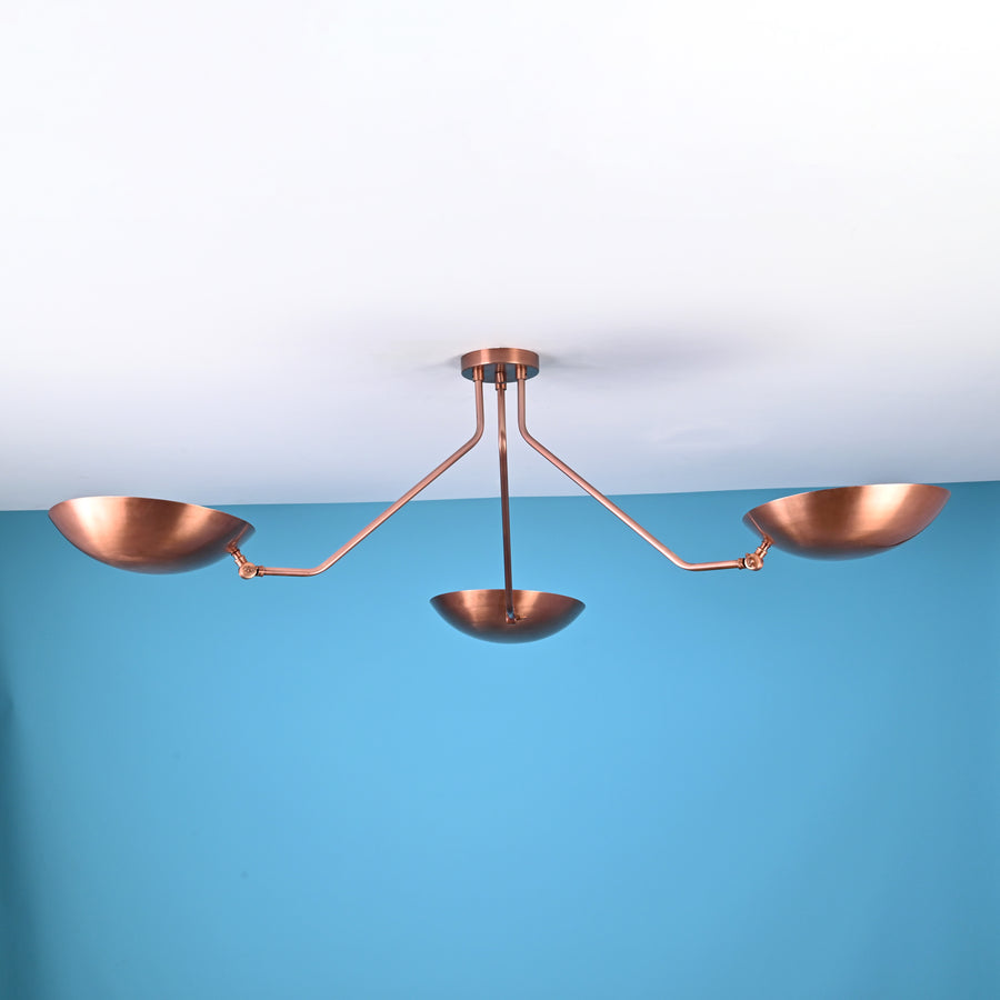 Modern 3 light brass flush mount ceiling light with bowl shaped shades and clean minimalist industrial arms