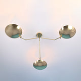 Bottom view of 3 light brass disc ceiling light with bowl shaped shades and clean symmetrical arms