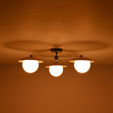 Installed view of 3 light brass disc flush mount ceiling light designed for low ceiling interiors.