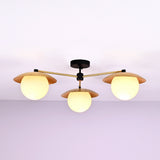 Front view of 3 light brass disc flush mount ceiling light with opal glass globes and modern industrial design.