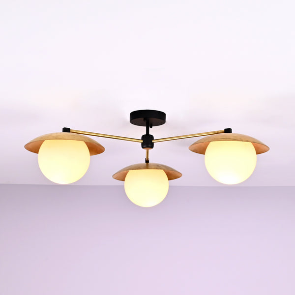 Front view of 3 light brass disc flush mount ceiling light with opal glass globes and modern industrial design.