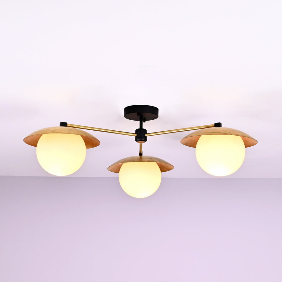 Front view of 3 light brass disc flush mount ceiling light with opal glass globes and modern industrial design.
