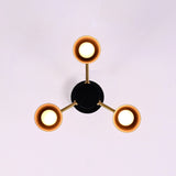 Top view of 3 light brass and black flush mount chandelier with cone shaped metal shades