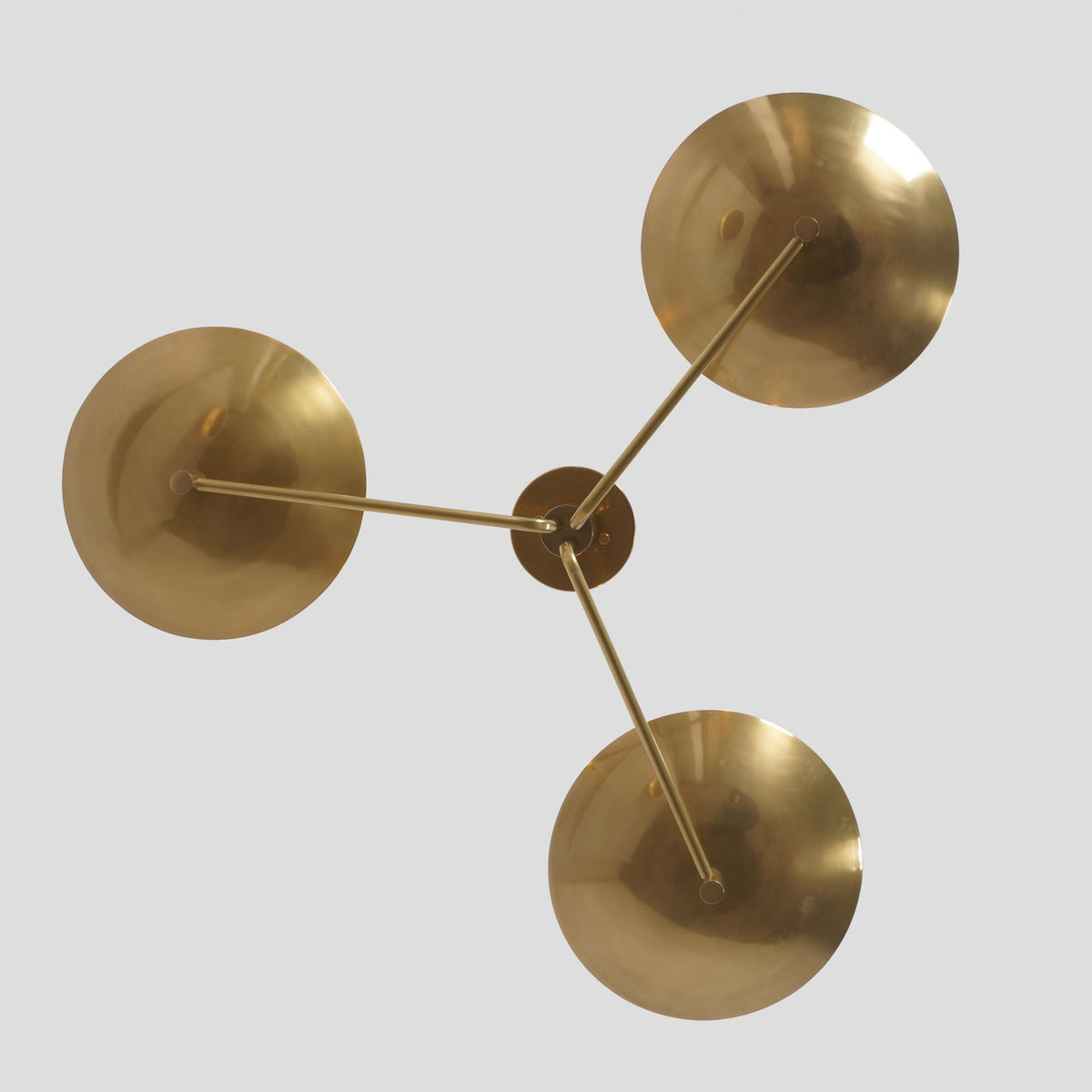 Top view of 3-light brass flushmount ceiling light showing elegant symmetry and handcrafted bowl design