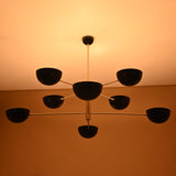 8-Light Brass Ceiling Fixture with Black Bowl Shades – Illuminated Pendant in Modern Interior