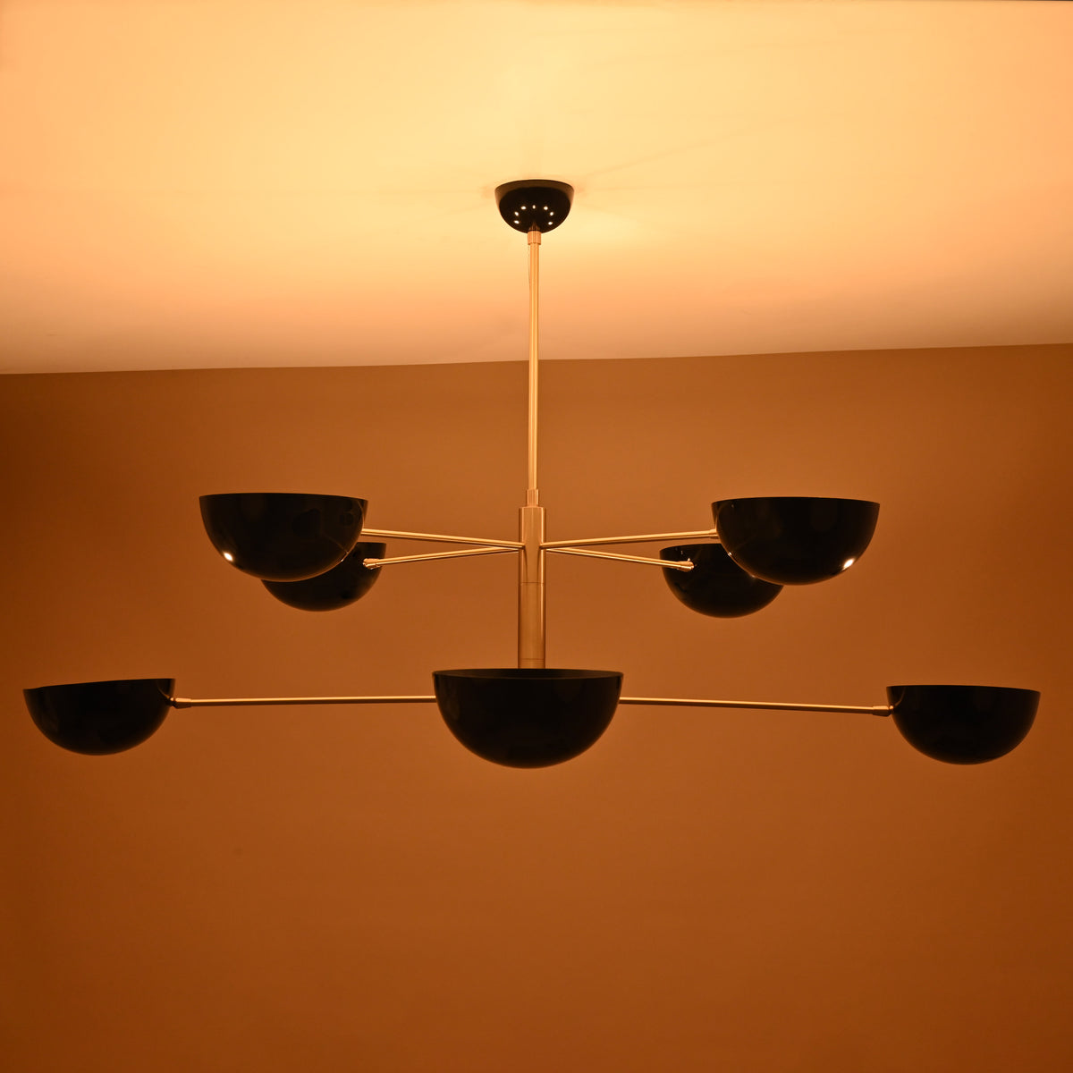 8-Light Brass Pendant Illuminated – Warm Ambient Glow with Black Bowl Shades