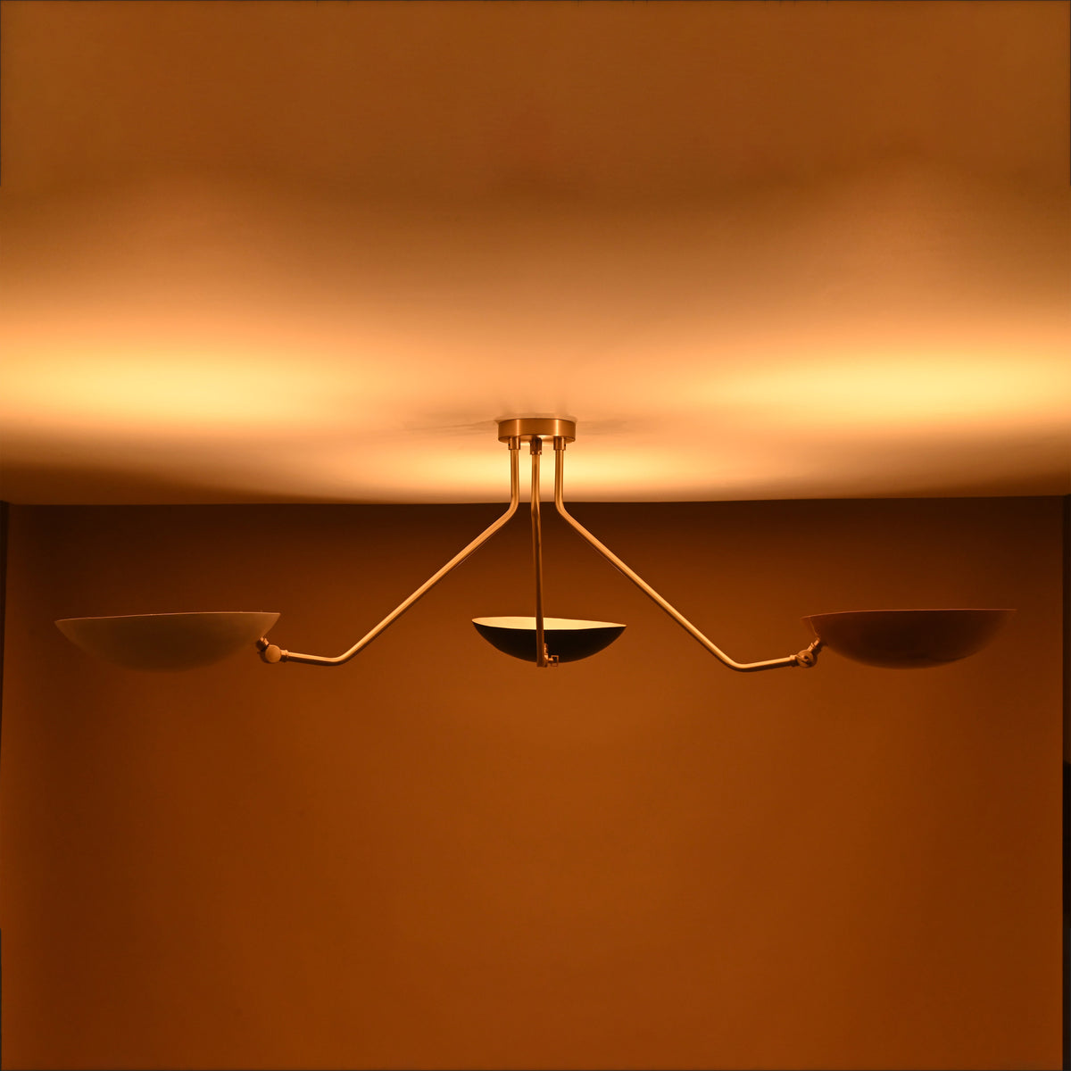 Tri-color bowl shade flushmount chandelier in warm lighting — brass 3-light ceiling light