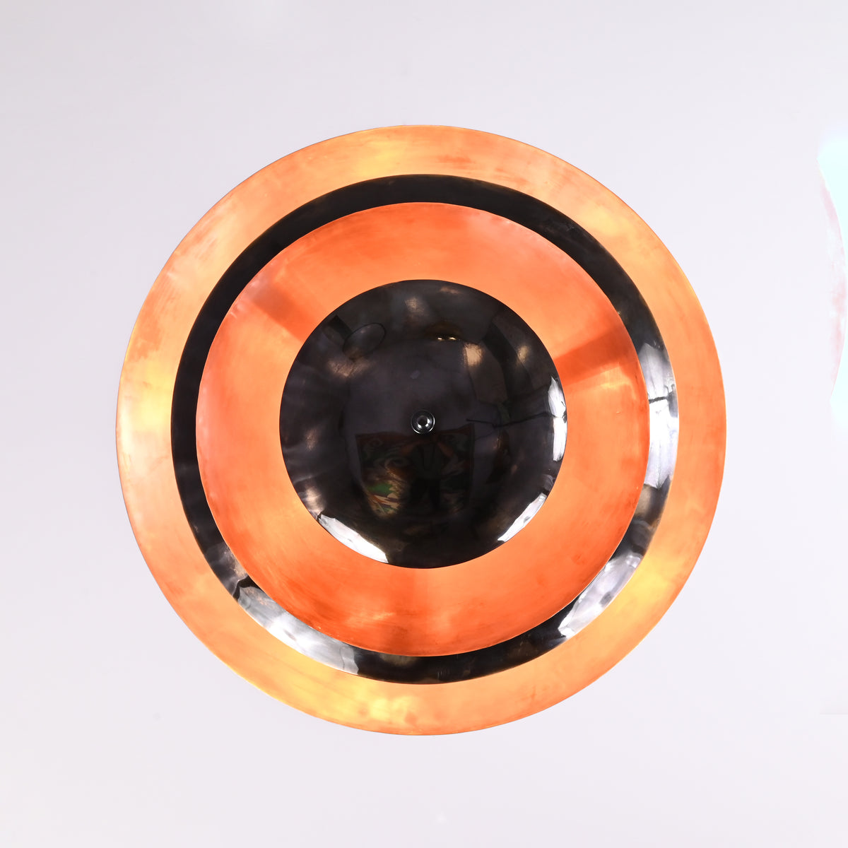Bottom view of layered bowl chandelier showing concentric copper and black rings