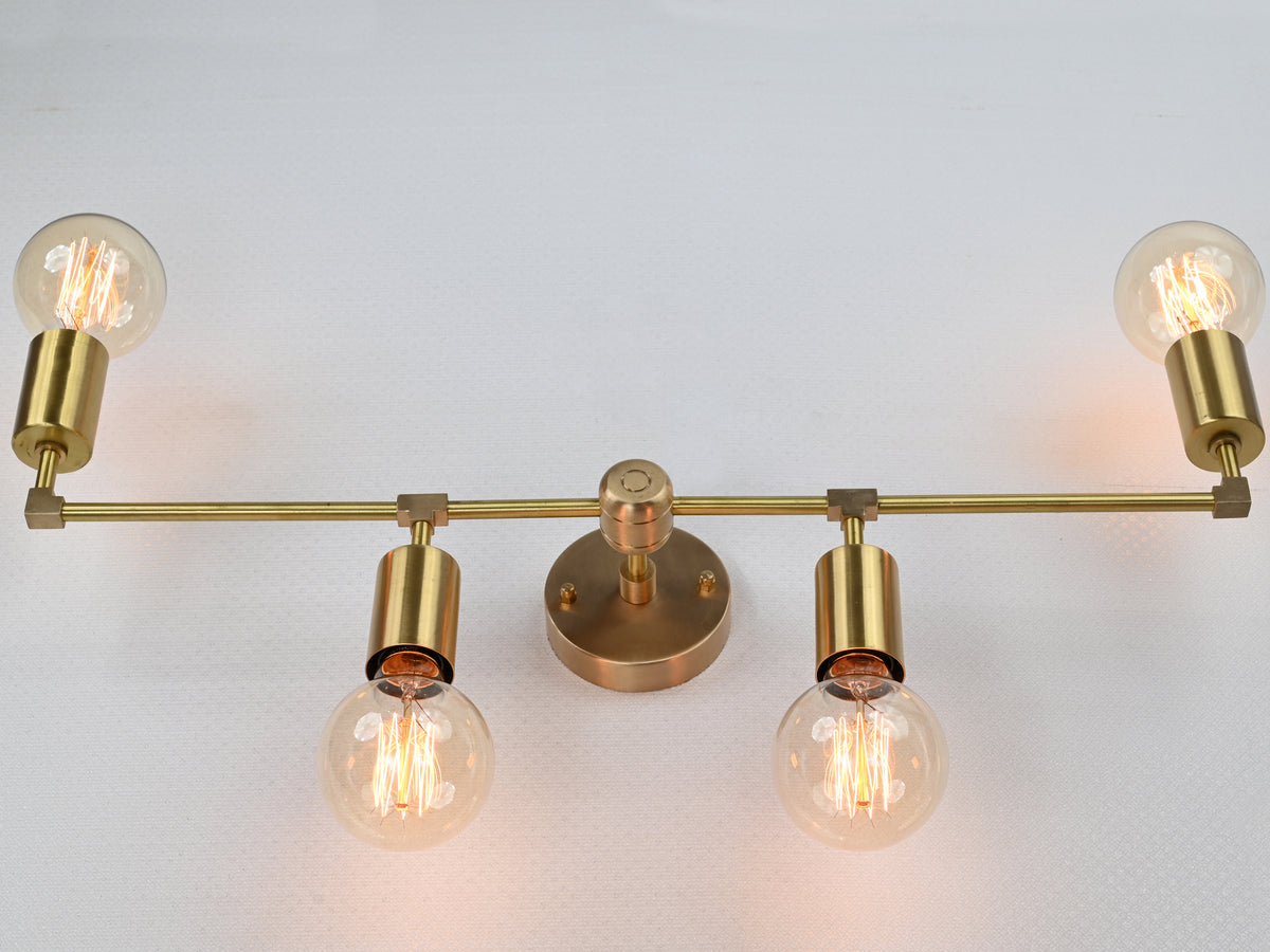 Modern four-light brass wall sconce with up-and-down lighting