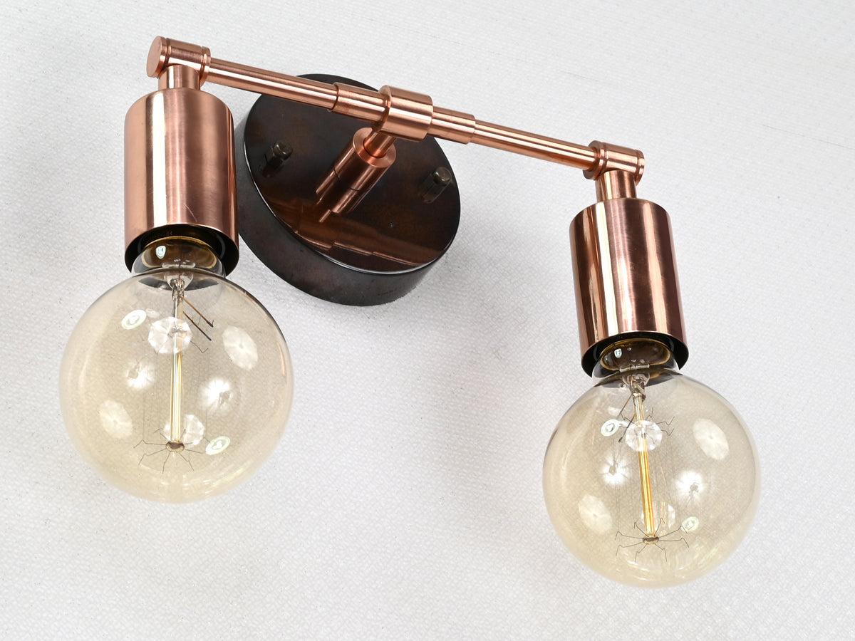 Modern compact brass wall sconce with balanced two-light design