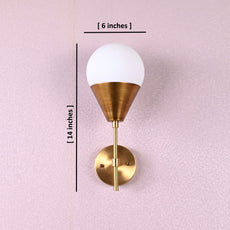 Brass wall sconce with frosted globe shade, cone-shaped base, and round wall mount, dimensions 6 x 14 inches.