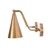 A modern wall-mounted sconce with a brushed brass finish, featuring a tapered cone shade, a curved adjustable arm, and a circular wall plate, shown against a plain white background.