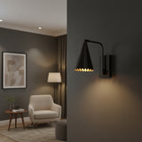 A modern beige armchair in a minimalist living room setting, styled with a matching throw pillow, a wooden sideboard, a black wall sconce, and a neutral abstract art print.