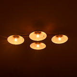 Four circular lights emitting a warm glow against a dark background