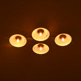 Four lit candles on a dark background