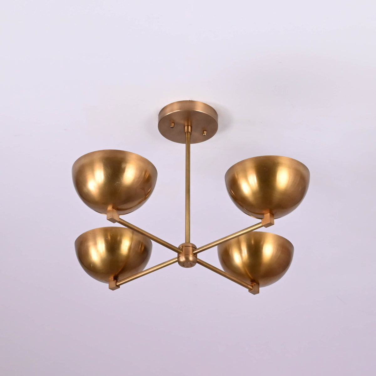 Bottom view of a 4 bowl brass ceiling chandelier highlighting symmetrical arms, bowl-shaped shades, and premium handcrafted brass construction.