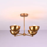 Side profile of a brushed brass 4 bowl chandelier displaying its clean horizontal arm structure and softly curved brass shades.