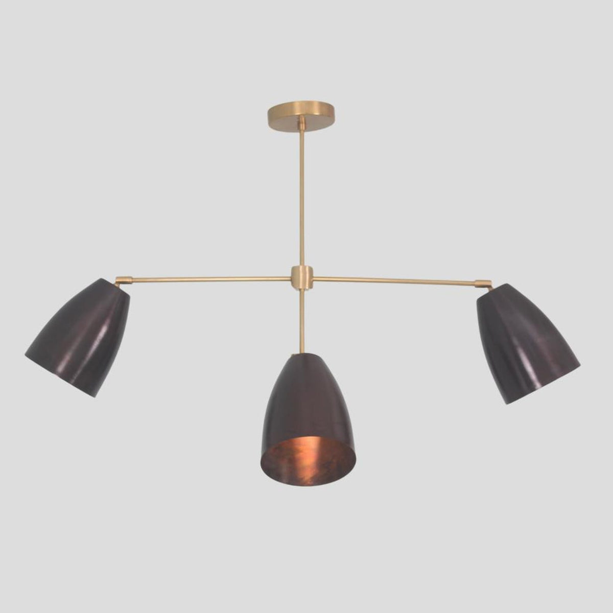 Center view of 4-light brass chandelier – contemporary pendant with cone shades for dining rooms, living spaces, and boutique interiors