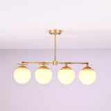 Front view of 4 linear brass chandelier with opal glass globe shades, showcasing minimalist industrial design and warm ambient lighting.