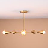 Side view of 5-light brass cone chandelier featuring sleek rods and precision-polished cones in satin brass finish, perfect for living or dining rooms.
