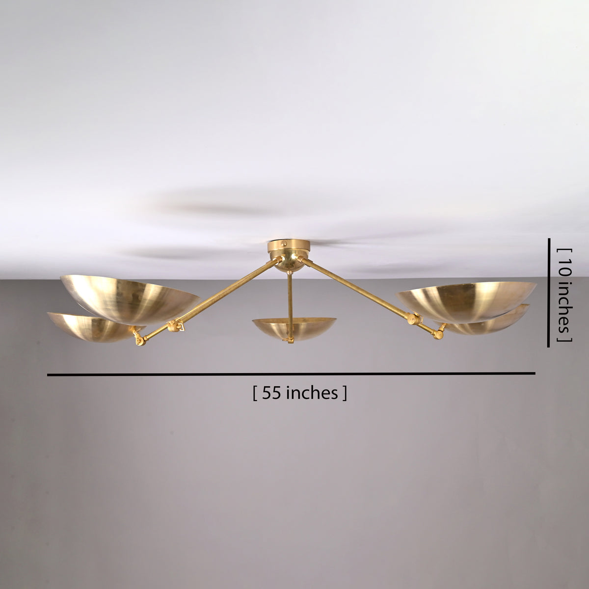 5-light brushed brass flushmount chandelier showing 55-inch width and 10-inch height dimensions with bowl-shaped shades.
