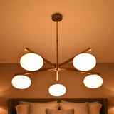 5-light chandelier with oval opal glass balls, brass arms, and clean modern ceiling-mounted design