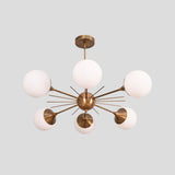 Contemporary Sputnik-style brass chandelier with six spherical white glass globes, creating an elegant ambient glow for modern interiors.