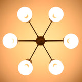Underside view of illuminated 6 Brass Diabolo chandelier highlighting warm indirect lighting and solid brass construction
