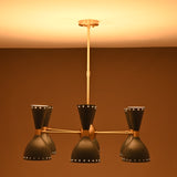 Moody lighting view of 6 Brass Diabolo 12-light chandelier with warm glow and luxury handcrafted brass finish