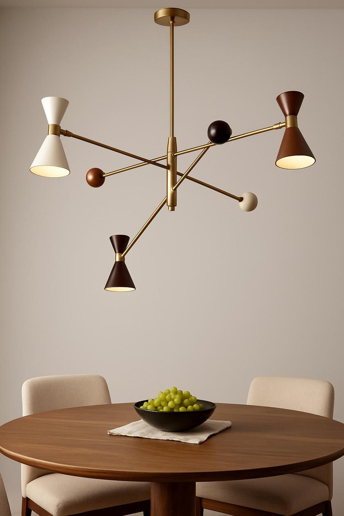 Sculptural 6-light diabolo style brass ceiling chandelier with geometric arms and warm ambient lighting