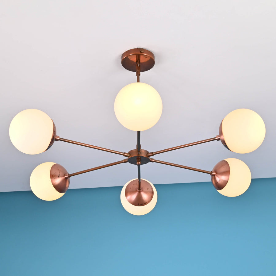 6 light glass globe brass chandelier with mid-century modern industrial design, solid brass arms and opal glass shades by Brass Leaf Studio