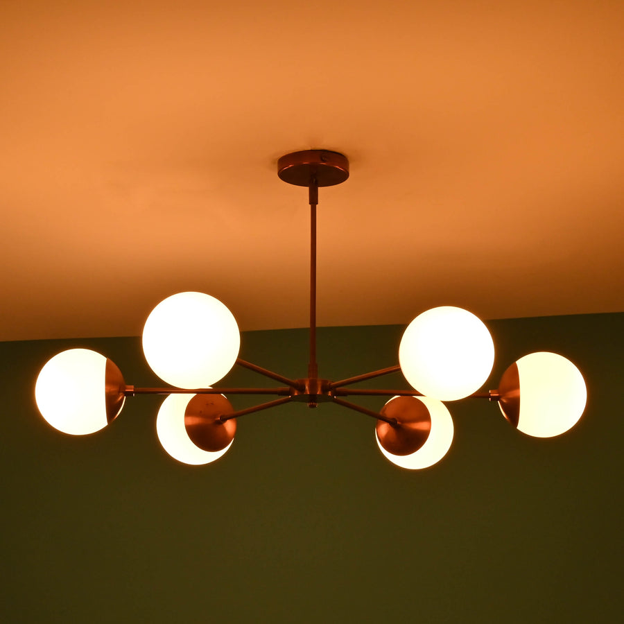 6 light glass globe brass chandelier with mid-century modern industrial design, solid brass arms and opal glass shades by Brass Leaf Studio
