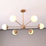 Mid-century style brass chandelier with six opal glass globes arranged symmetrically in a radial form.