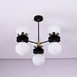 Bottom view of six light brass chandelier featuring opal glass globes and layered disc design