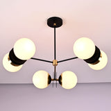 Symmetrical view of a handcrafted brass chandelier with six opal glass globes and minimalist industrial styling.