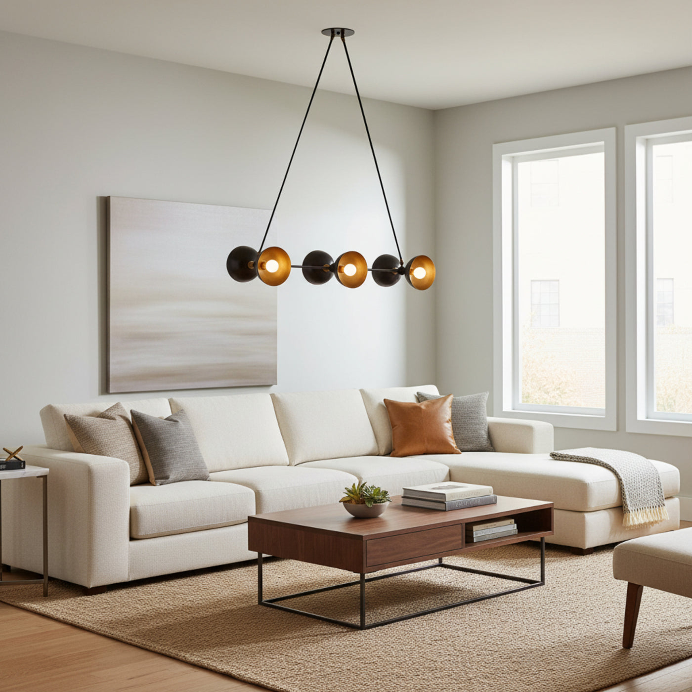 Modern multi-light chandelier with four black spherical shades and four brushed gold conical reflectors, suspended by black cords from a round ceiling canopy on a white background.
